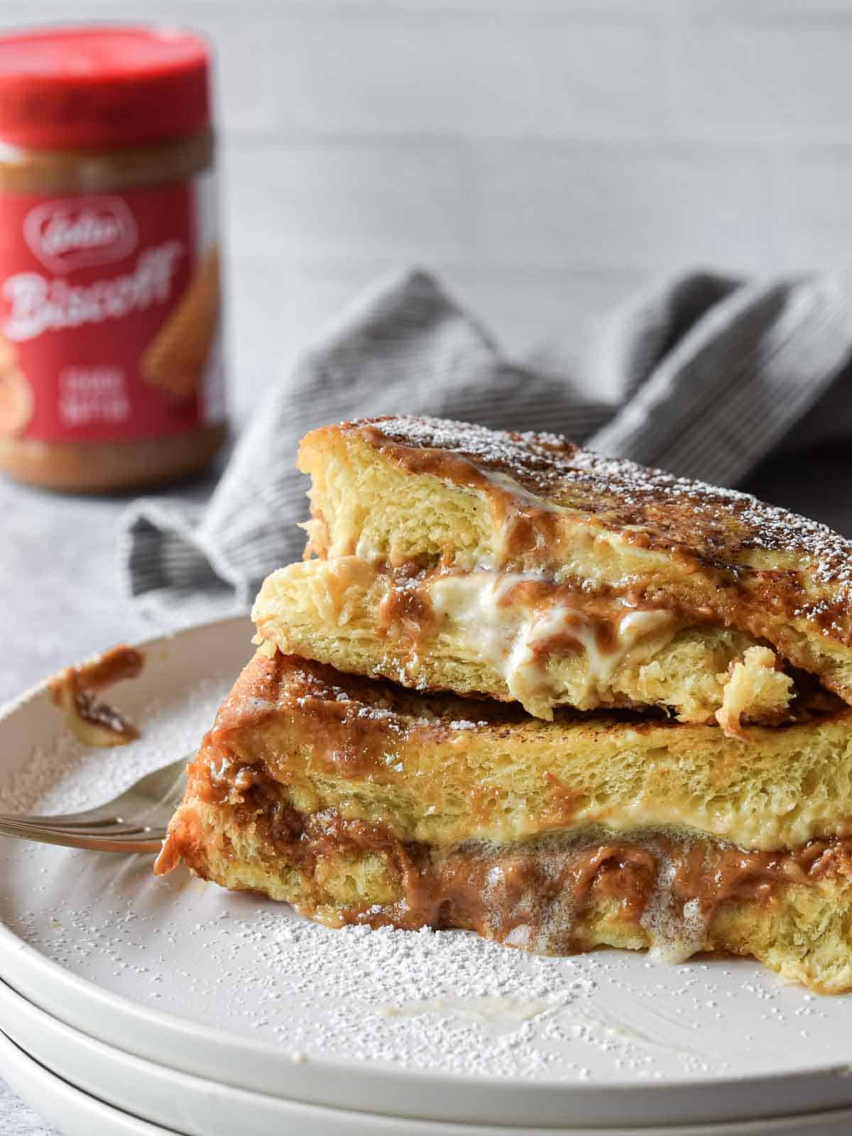Stuffed French toast stacked on top of each other on a white plate.