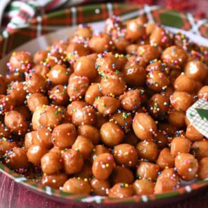 Italian honey balls on a Christmas plate.