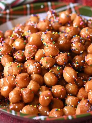 Italian honey balls on a Christmas plate.