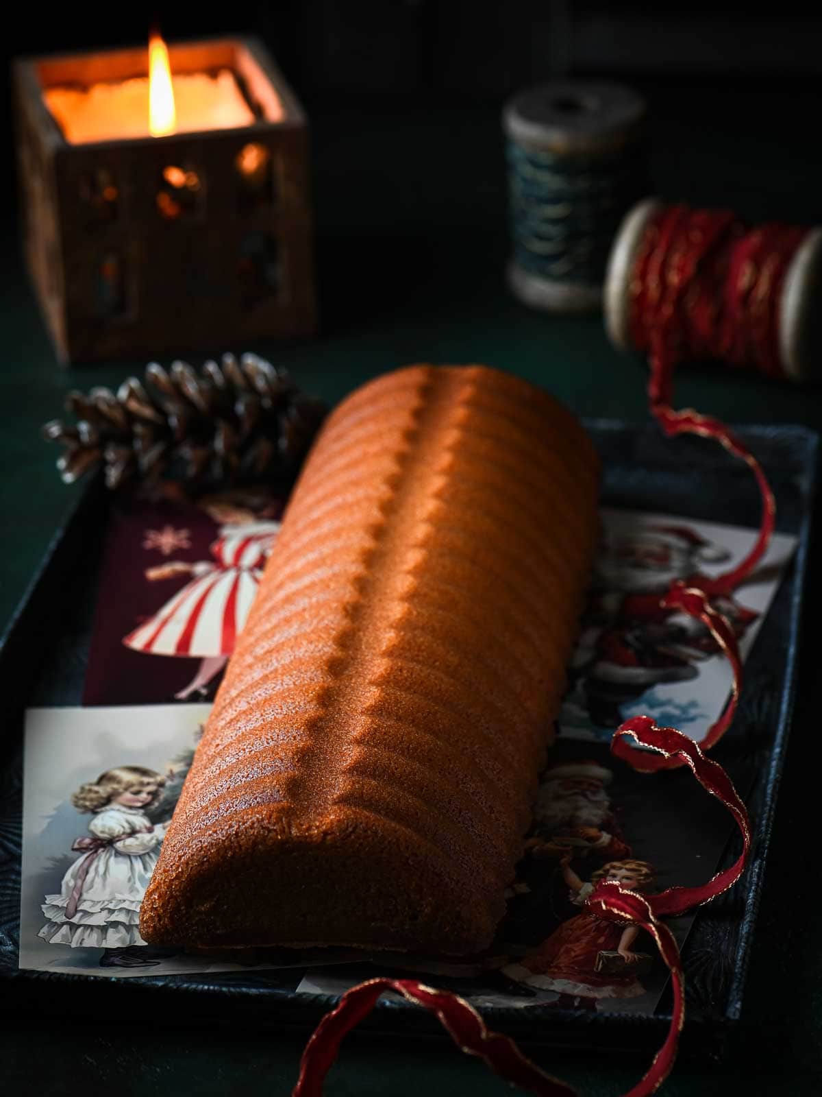 Moody picture of an almond cake with no decorations highlighting the ridges of the cake.