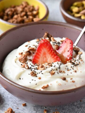 Close up of a cottage cheese breakfast bowl with strawberries on top.