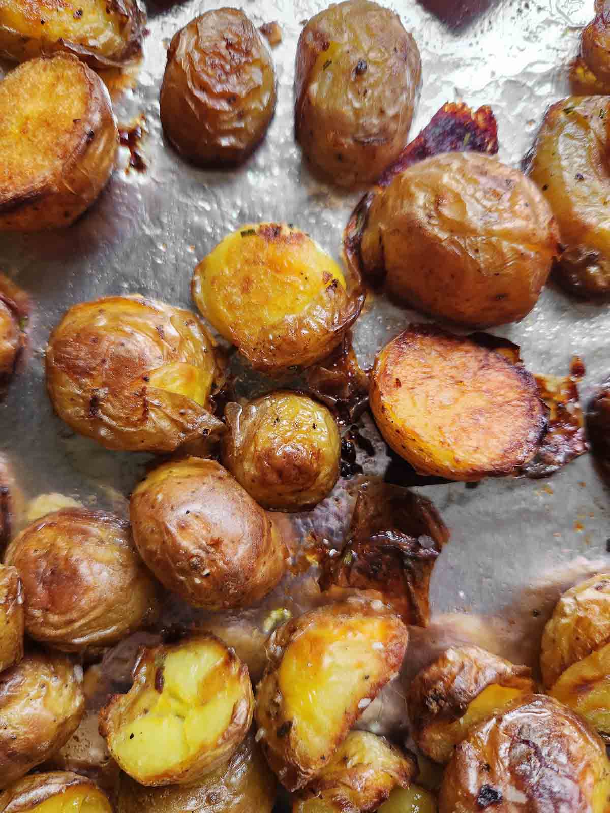 Roasted crispy potatoes on a baking sheet.