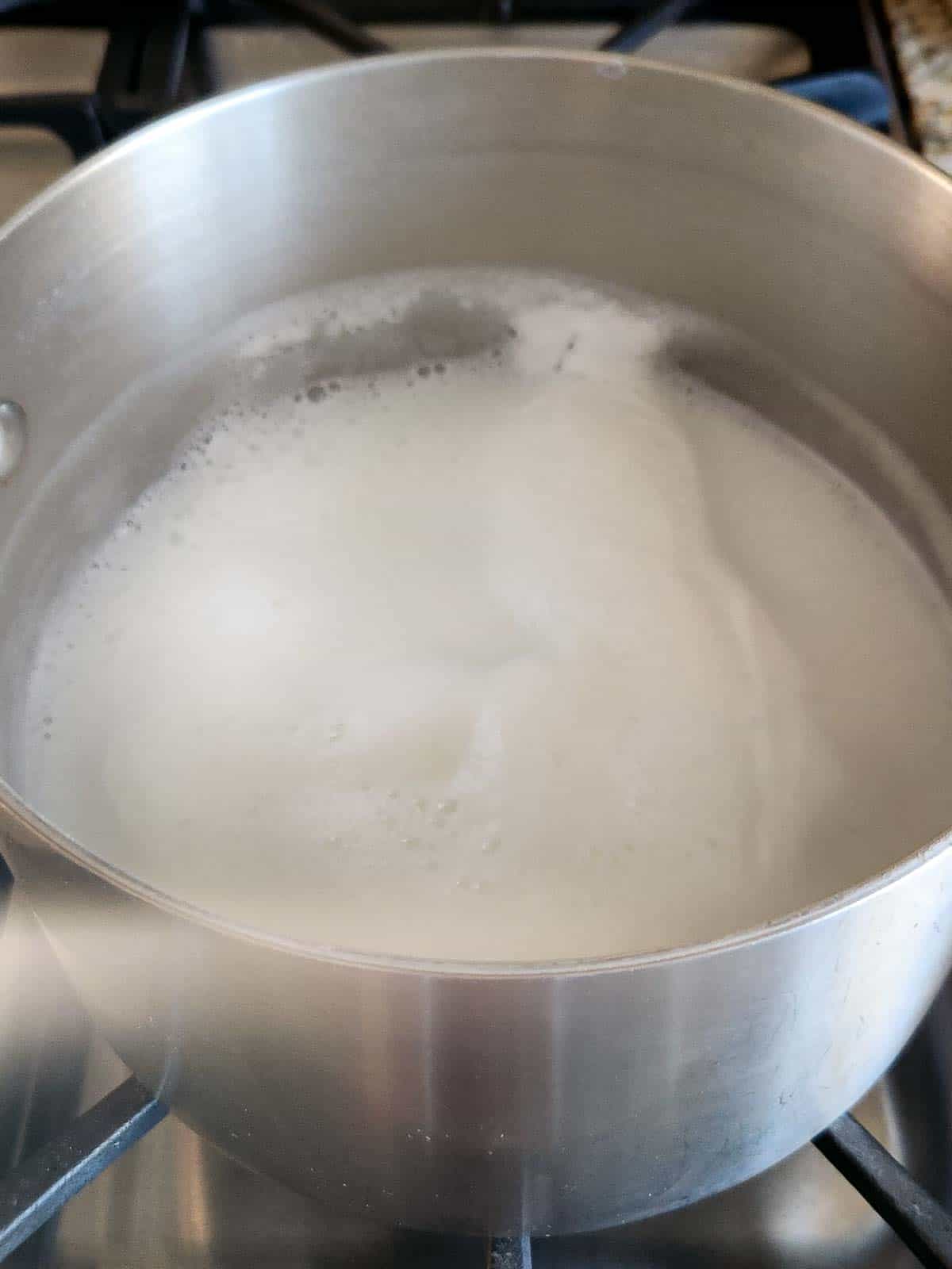 Boiled milk in a stainless tell pot.
