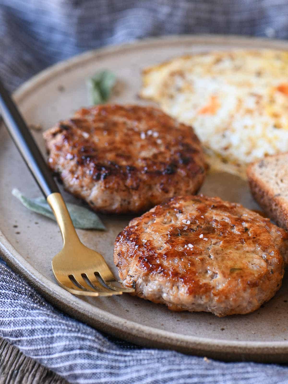 Delicious grilled breakfast sausage patties served with scrambled eggs and toasted bread at Brunch & Batter.