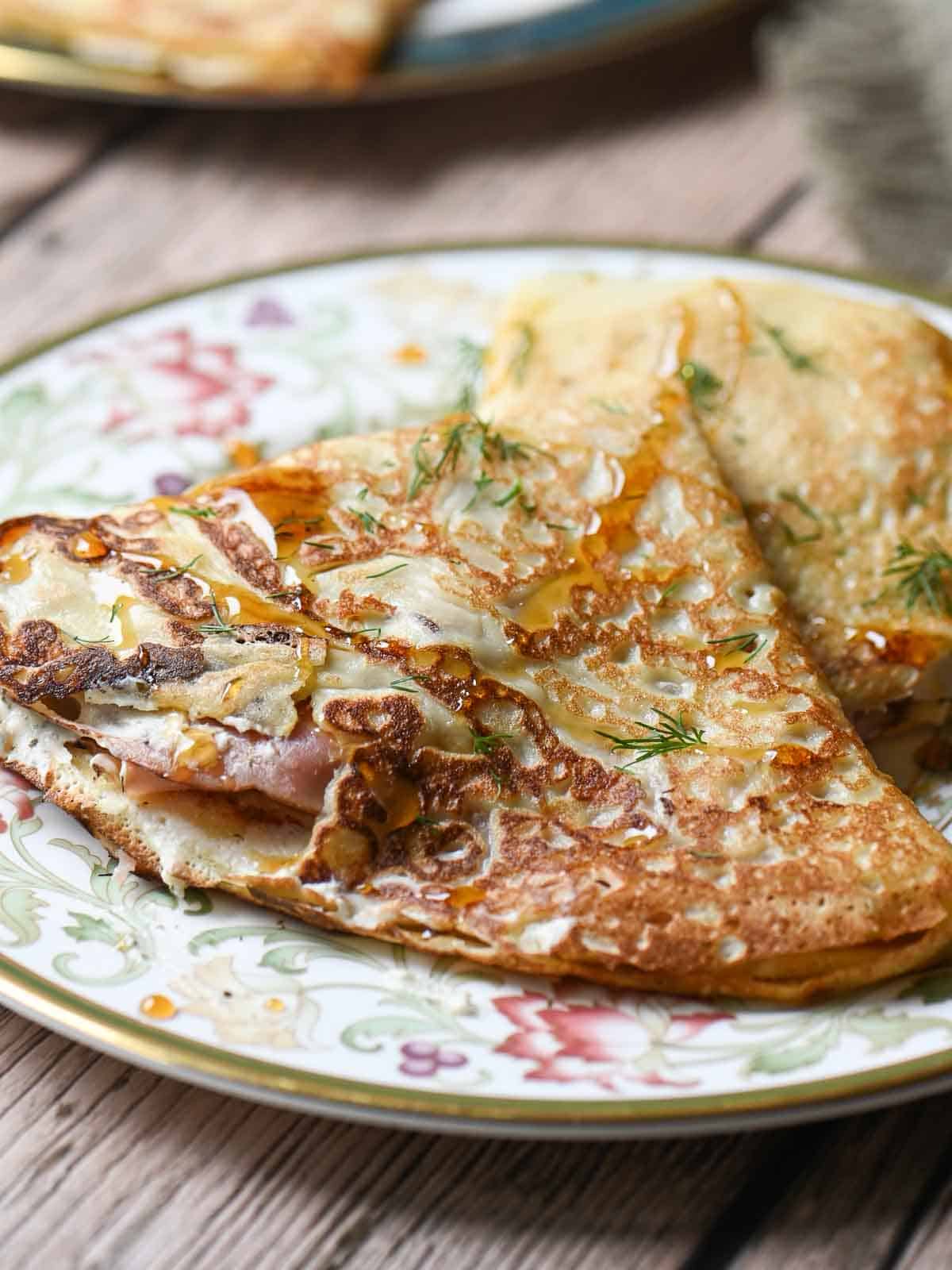 Crepes on a flowered plate.