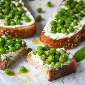 Close up of pea toast cut in half with mascarpone and lemon.