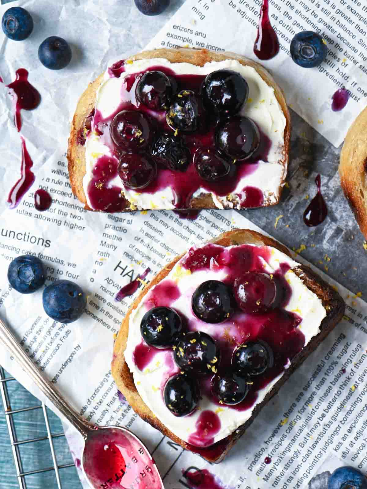 Overhead of blueberry toast on parchment paper.