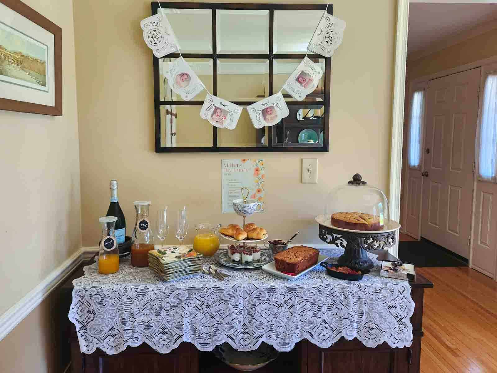 A buffet table decorated with a lace tablecloth and self-serve brunch items.
