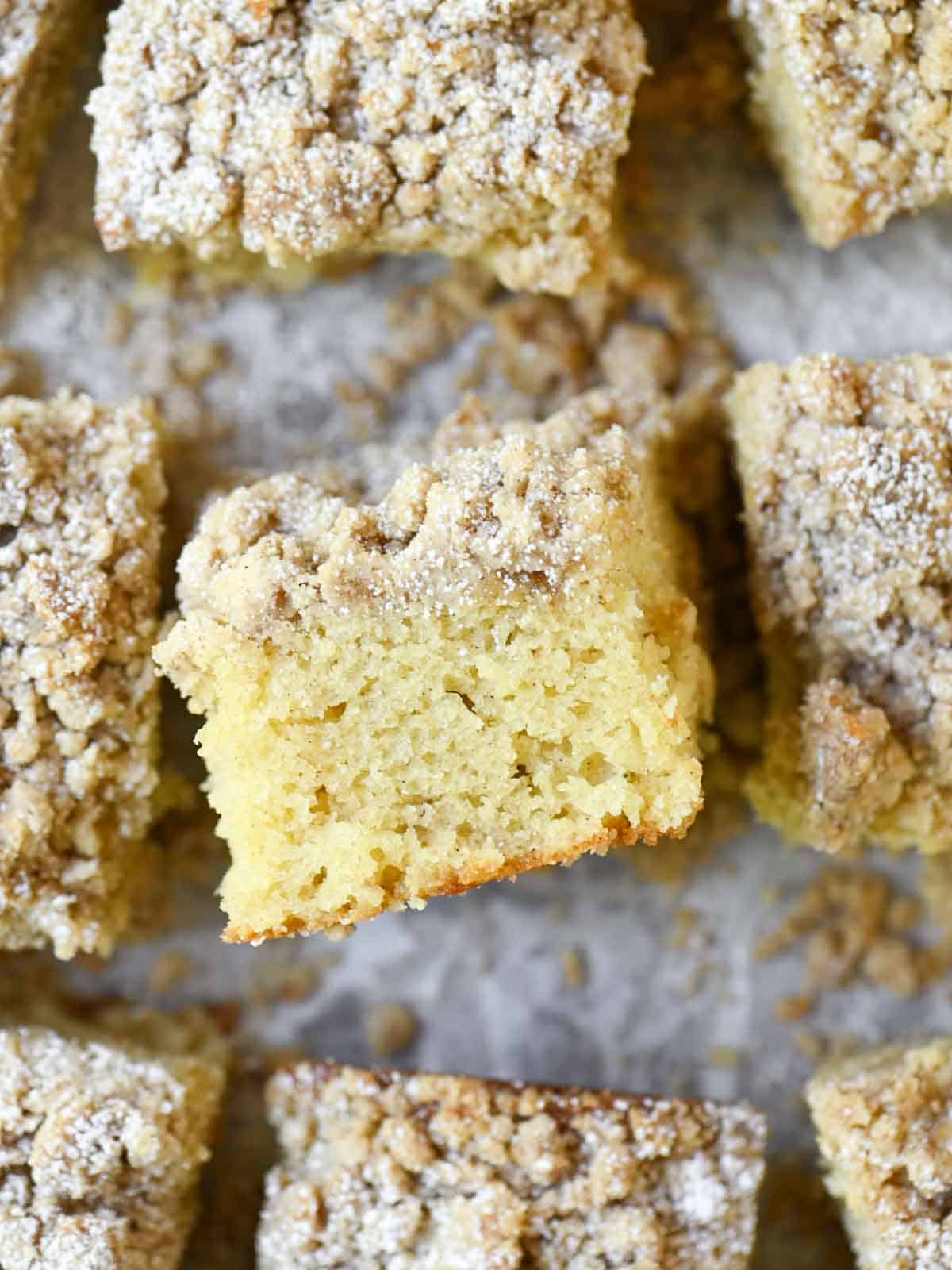 A slice of coffee cake turned on its side showing the crumb topping.