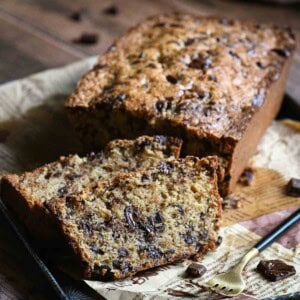 Slices of chocolate loaf cake on a metal tray lines with parchment.