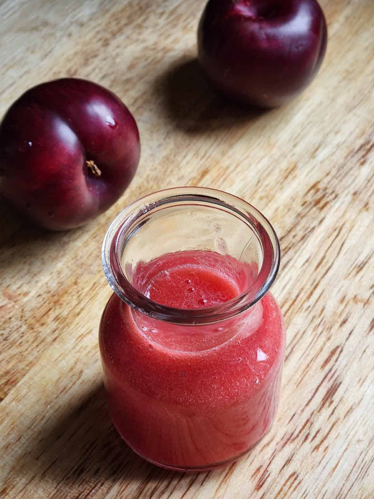 Plum puree in a clear jug.