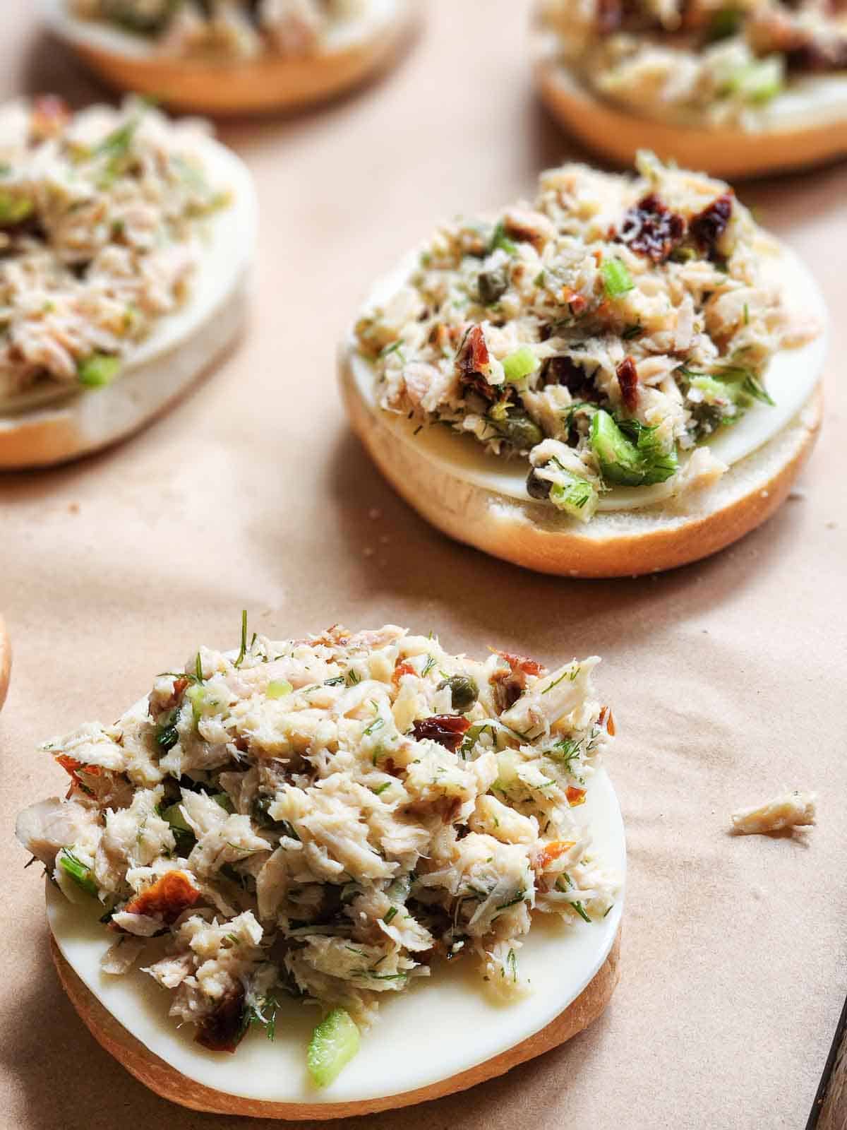 Close-up of tuna and cheese on a bagel.