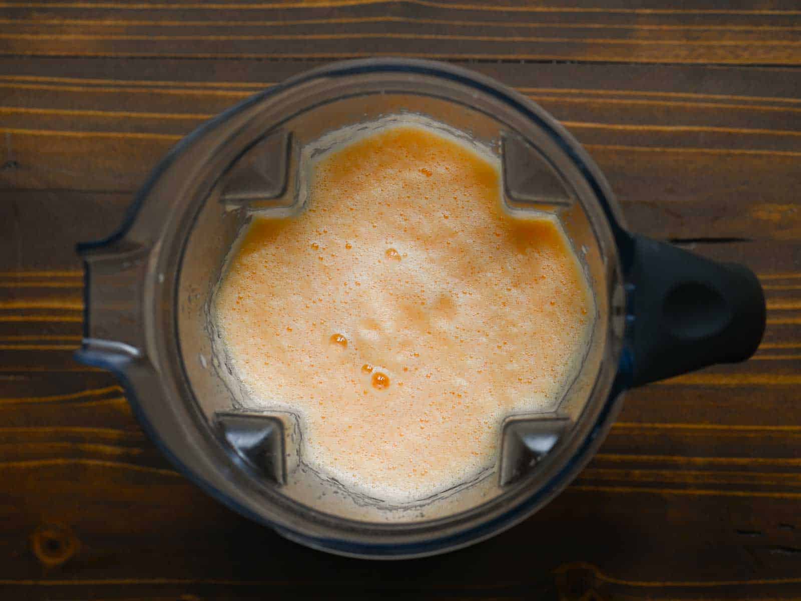 Overhead of blended cantaloupe drink in a blender.