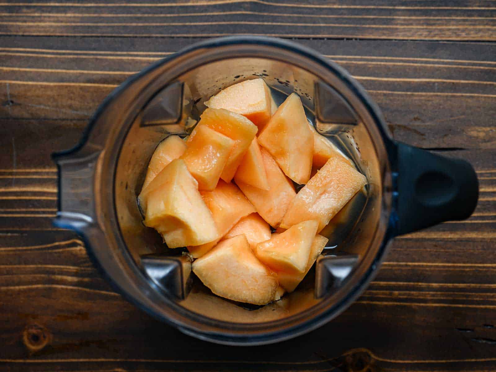 Overhead of cantaloupe in a blender.