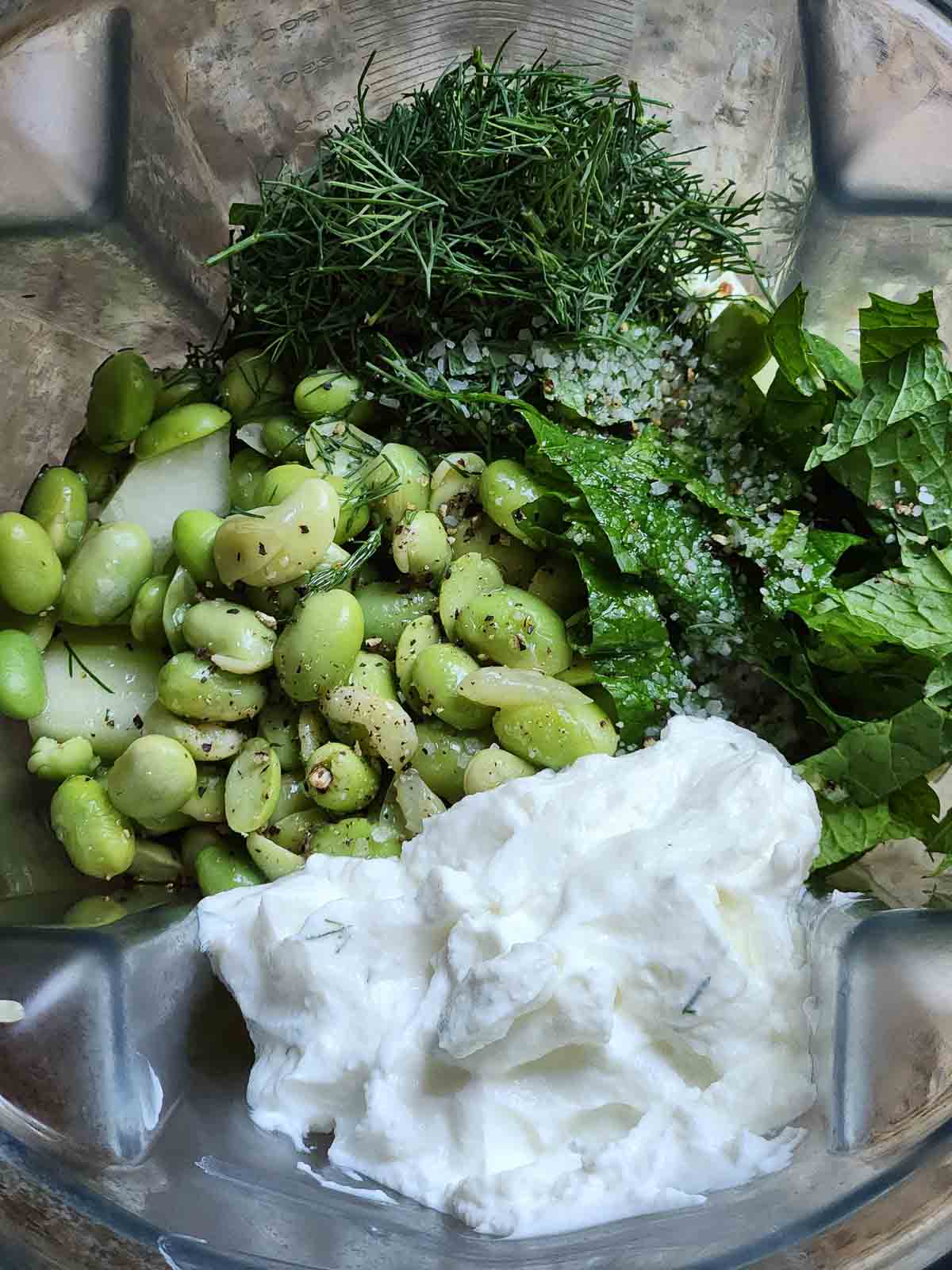 Overhead of cucumber soup ingredients in a blender.