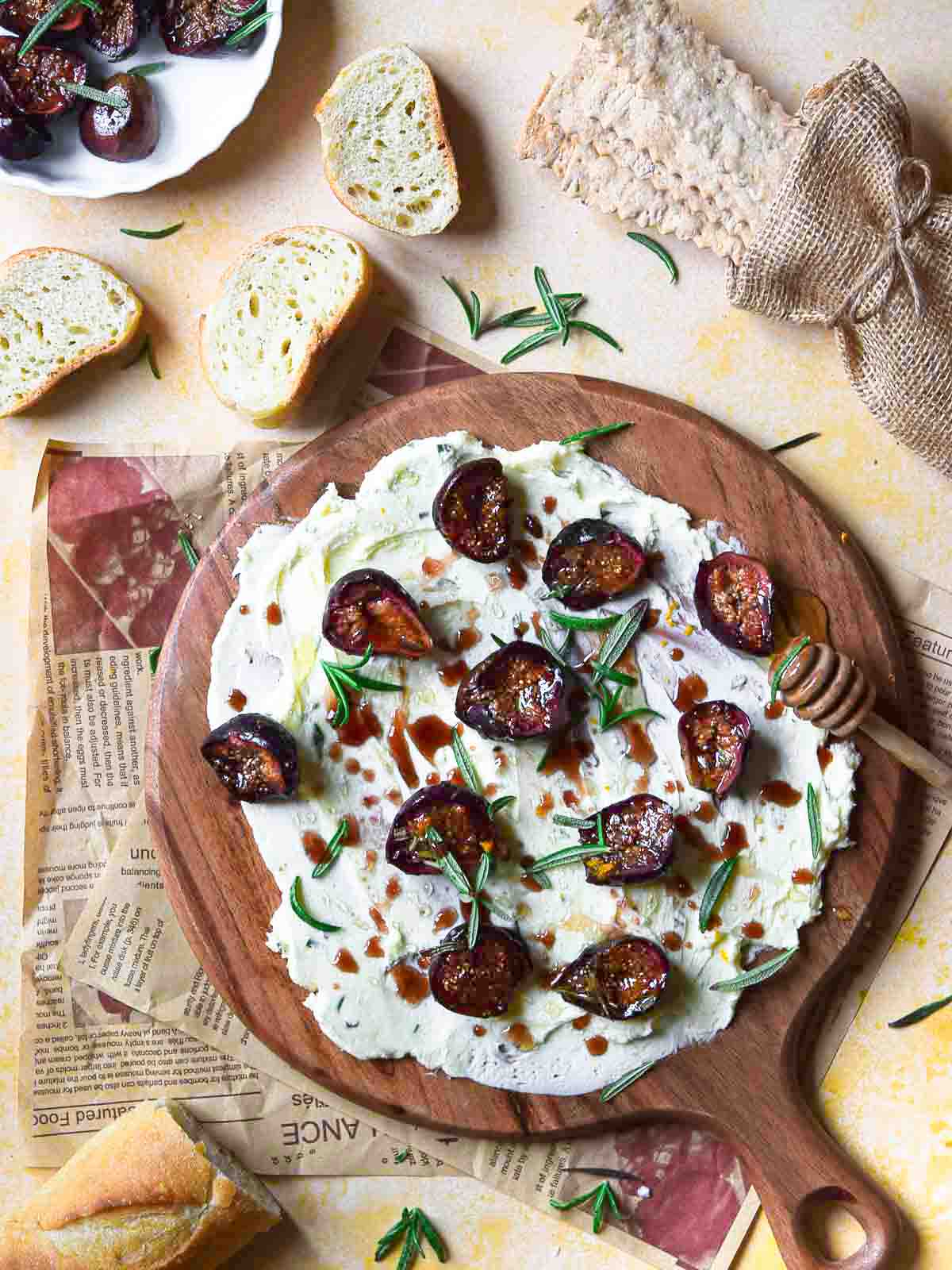 Figs and butter on a round wooden board.