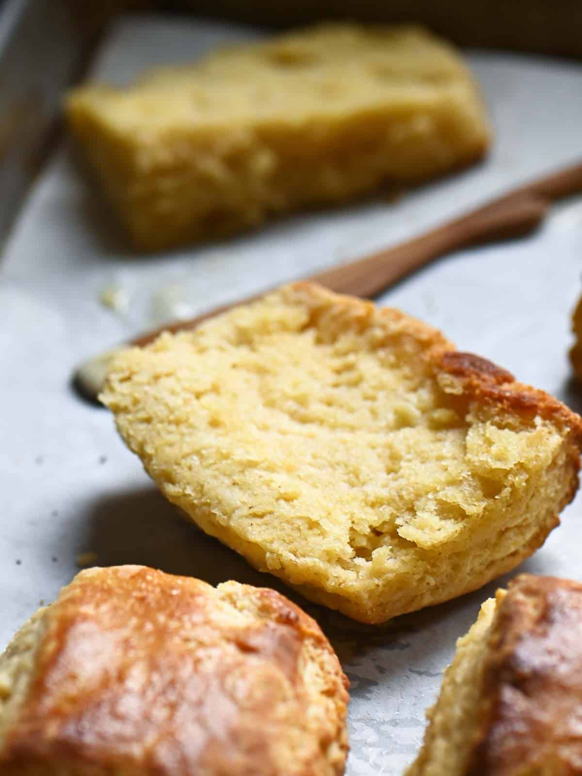 A cut-open biscuit showing the fluffy inside on a tray.