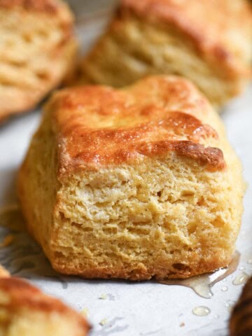 Close up of a square biscuit on parchment paper.