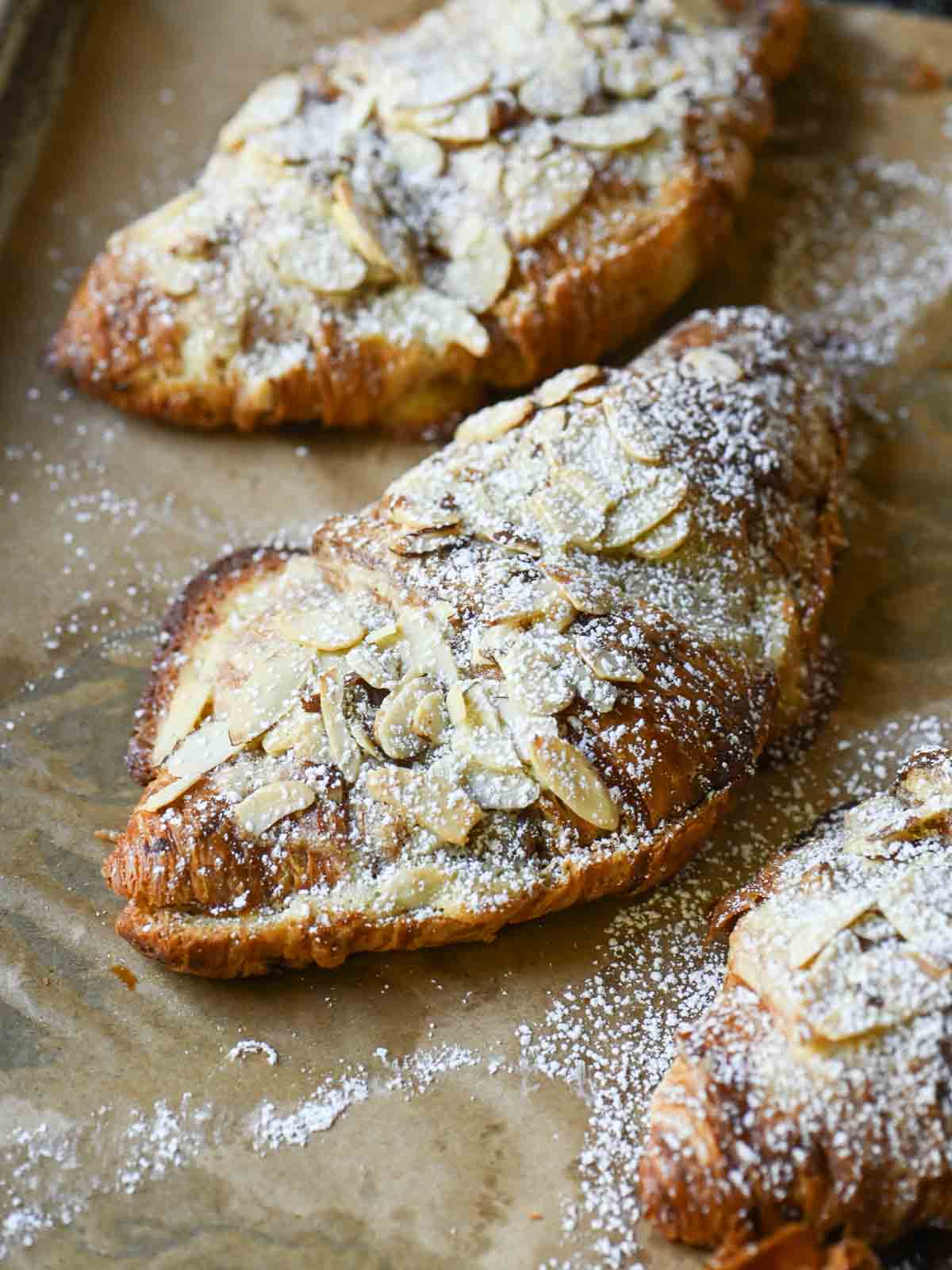 Angled view of the tops of almond croissants.