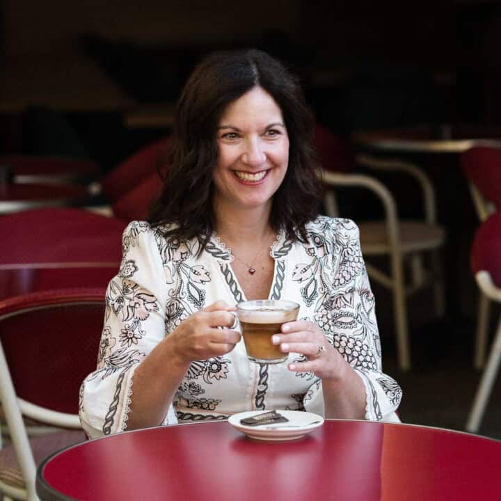Author sitting at a coffee drinking coffee.