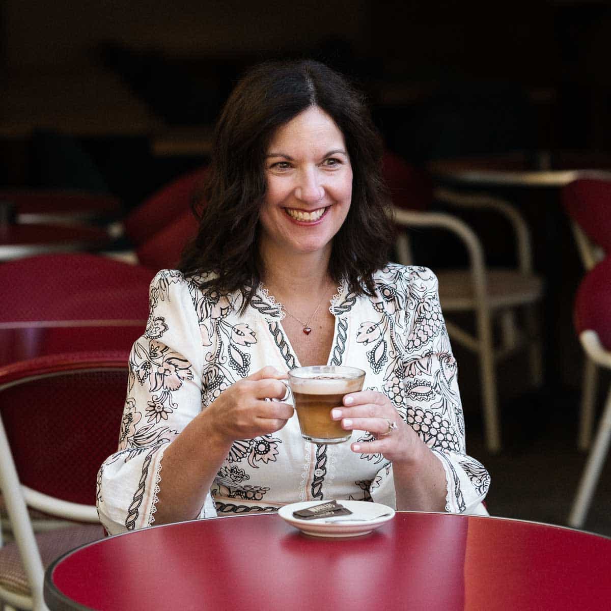 Author sitting at a coffee drinking coffee.